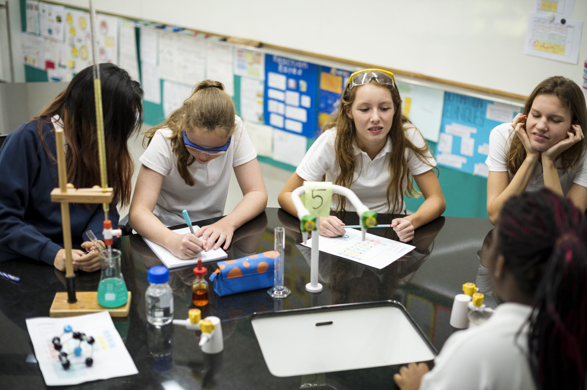 High school students studying in chemistry laboratory experiment class